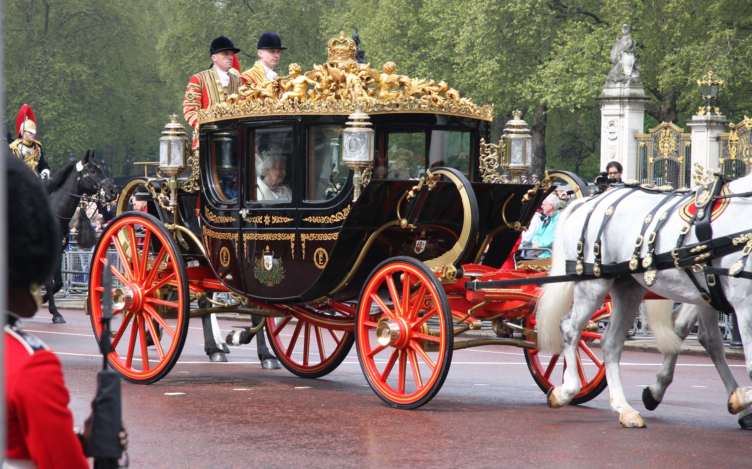 The Queen in a horse drawn royal carrage